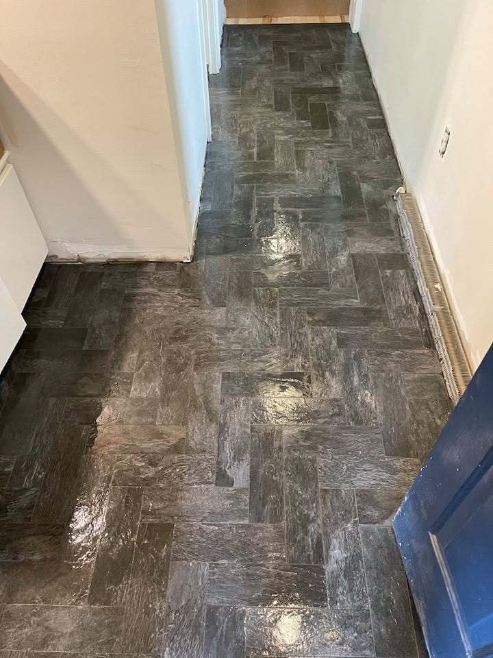 Dark slate herringbone tile flooring in hallway