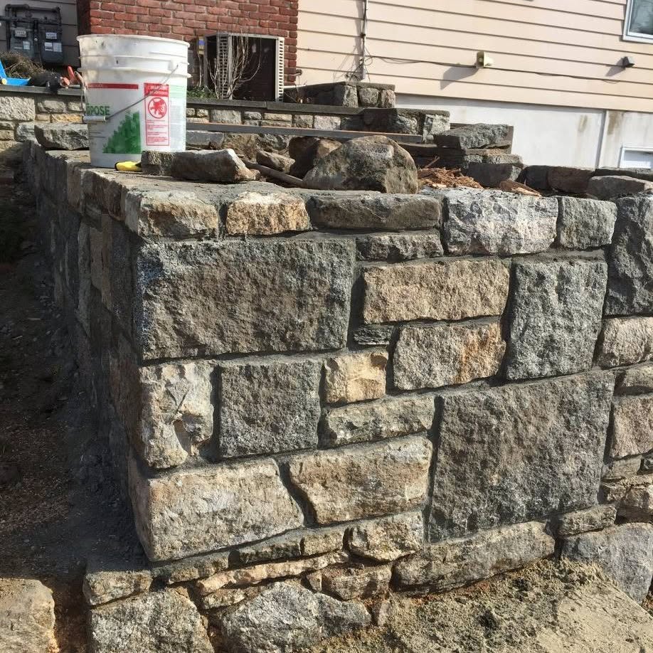 Natural fieldstone wall under construction