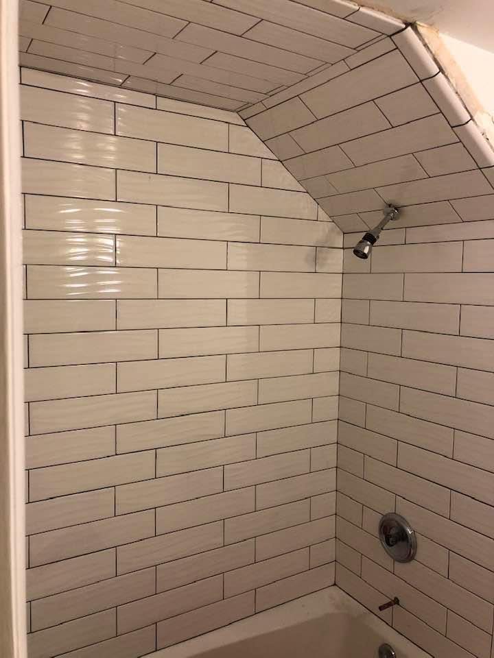 White subway tile shower with vaulted ceiling